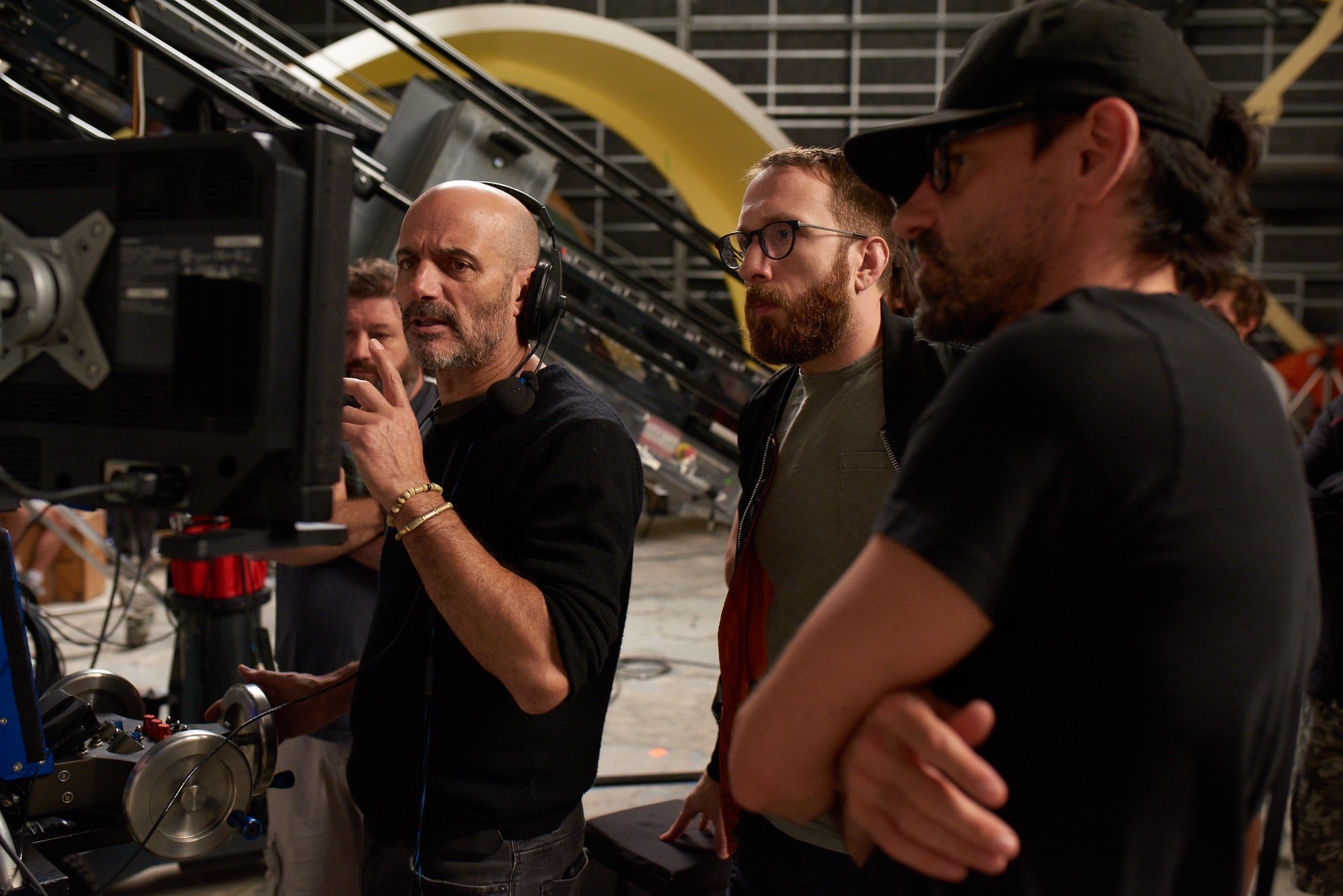 The crew watching takes at the monitors