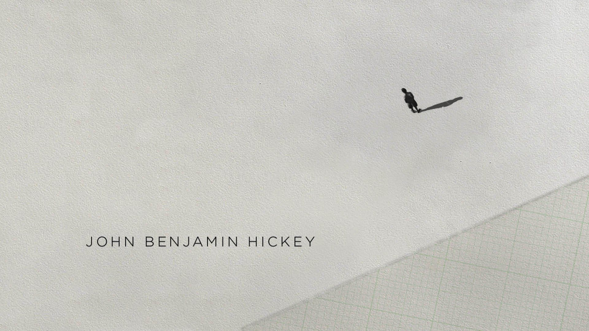 A single figure crossing a blank page beside a cast credit